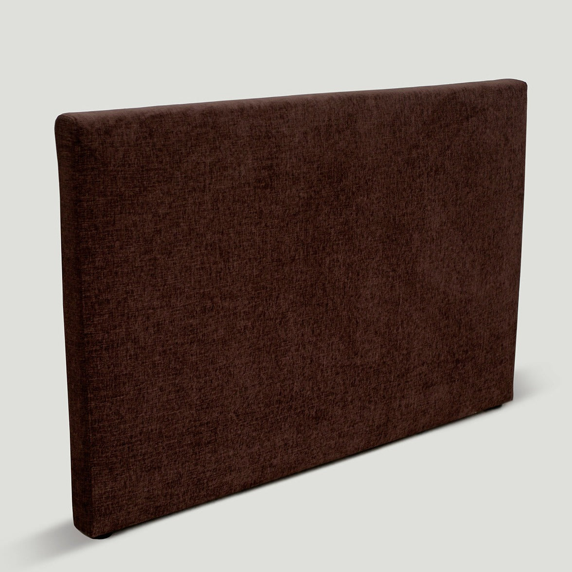 Upholstered Cosmos Bedhead in Mocha fabric, side view showing soft rectangular silhouette. Upholstered Cosmos Bedhead in Mocha fabric, side view showing soft rectangular silhouette.