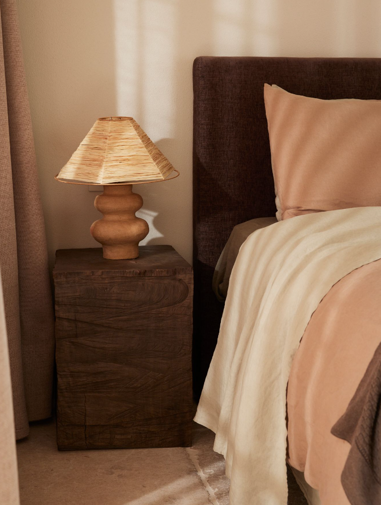 Side view of the Cosmos Bedhead in Mocha fabric, styled in a modern bedroom with neutral bedding. Side view of the Cosmos Bedhead in Mocha fabric, styled in a modern bedroom with neutral bedding.