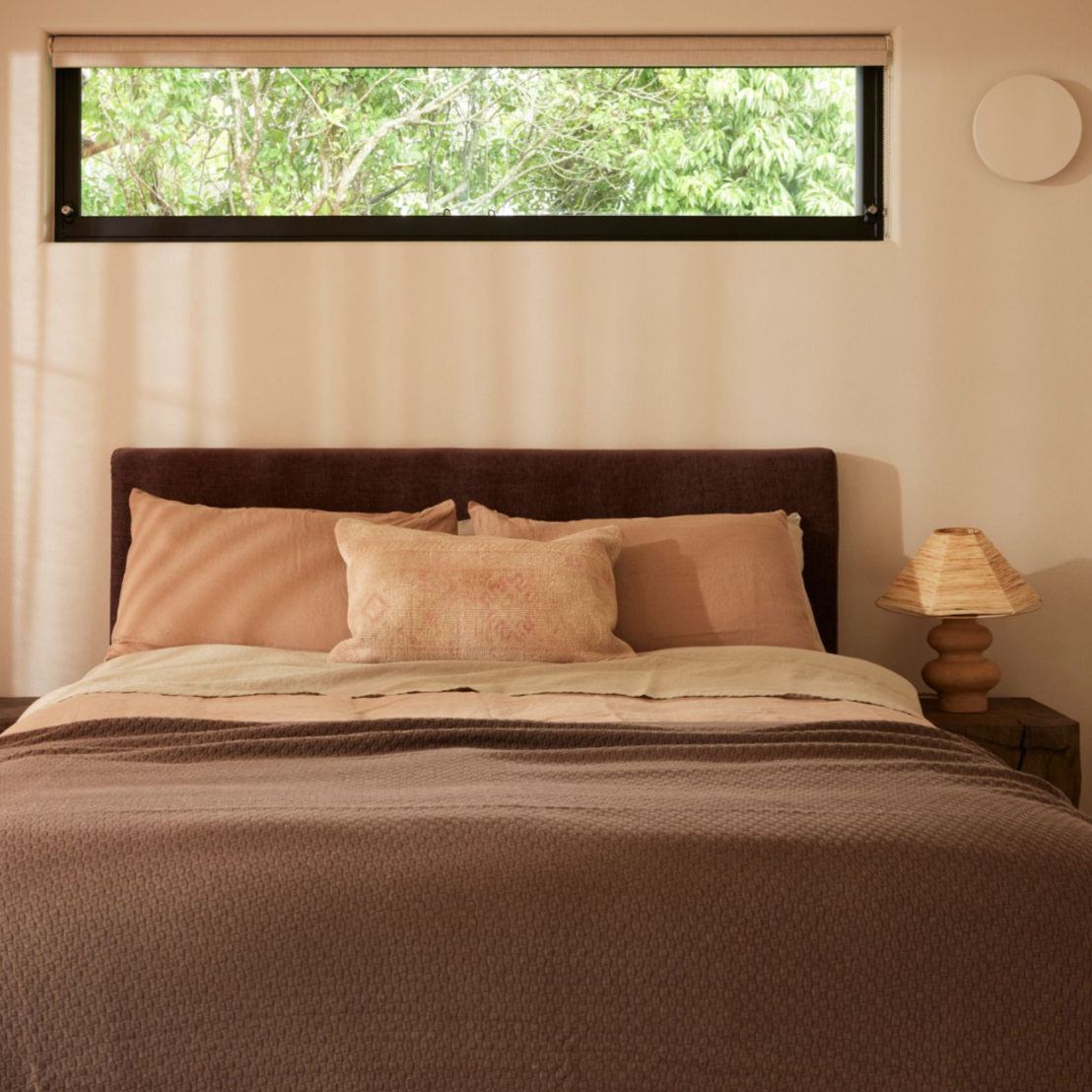 Cosmos Bedhead in Mocha fabric, styled in a modern bedroom with neutral bedding. Cosmos Bedhead in Mocha fabric, styled in a modern bedroom with neutral bedding.