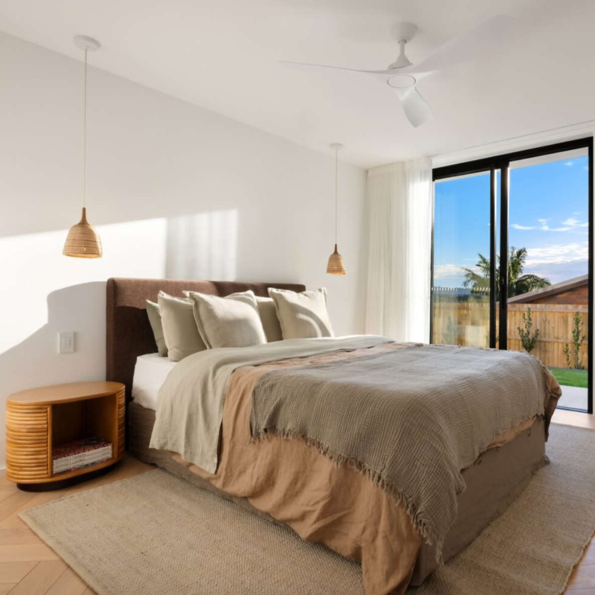 Cosmos Bedhead in Mocha fabric, styled in a modern bedroom with neutral bedding. Cosmos Bedhead in Mocha fabric, styled in a modern bedroom with neutral bedding.