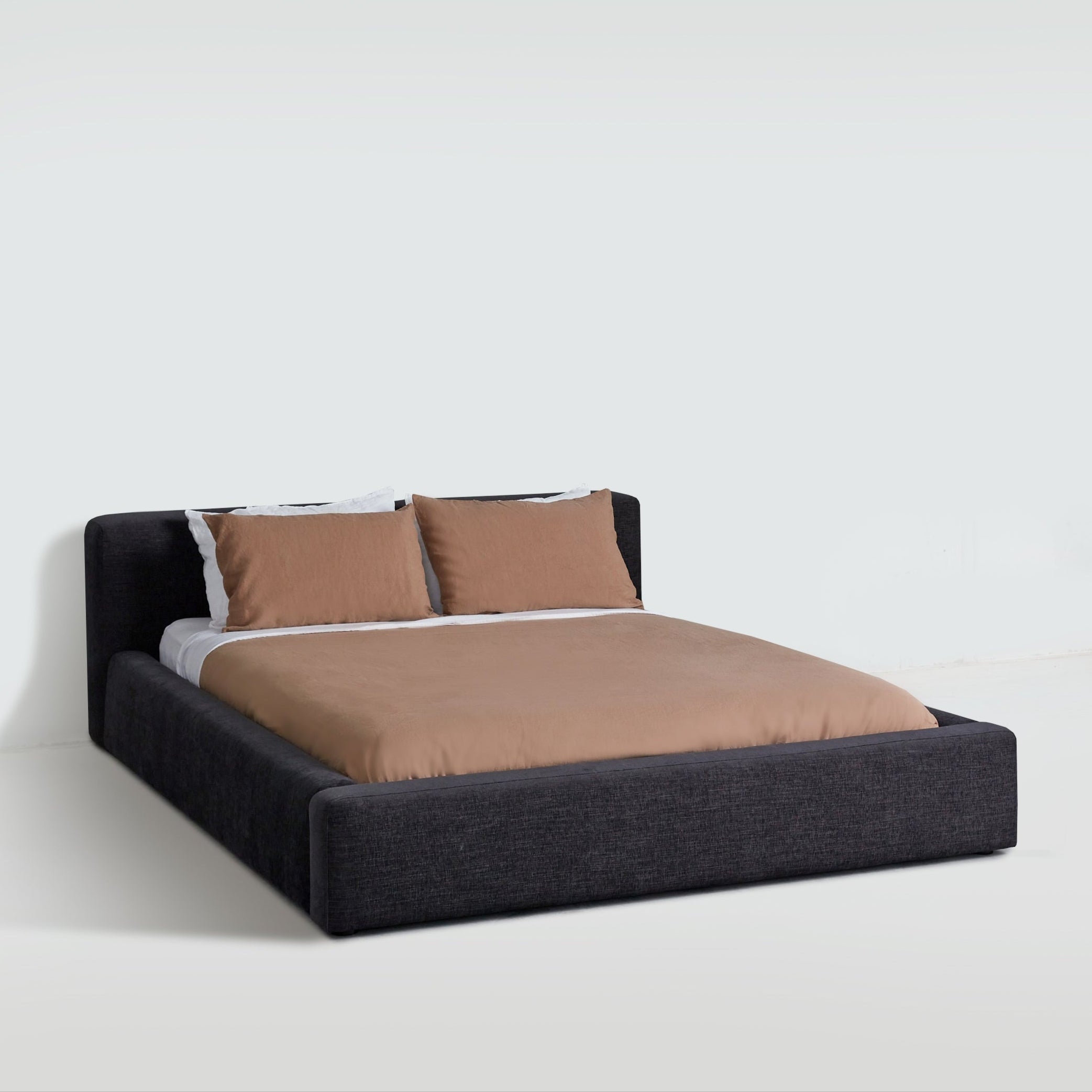 Cosmos upholstered bed in Charcoal fabric, three-quarter angle highlighting soft edges and platform frame. Cosmos upholstered bed in Charcoal fabric, three-quarter angle highlighting soft edges and platform frame.