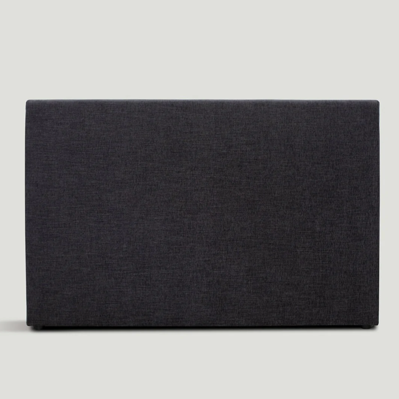 Upholstered Cosmos Bedhead in Charcoal fabric, front view showing soft rectangular silhouette. Upholstered Cosmos Bedhead in Charcoal fabric, front view showing soft rectangular silhouette.
