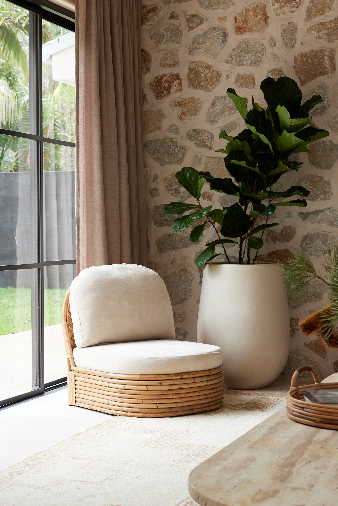Pablo Rattan Armchair styled in a natural modern interior setting