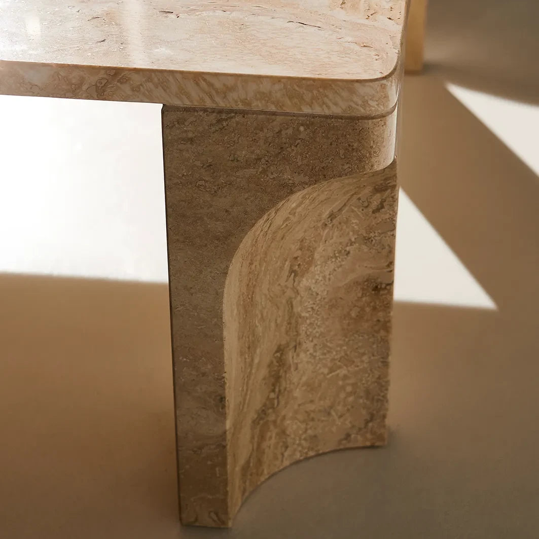 Close-up of the white travertine Doric Coffee Table leg, revealing the fluted detailing and natural stone texture.