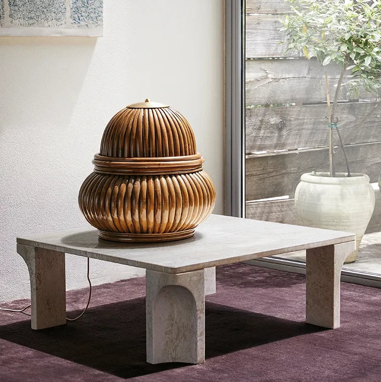 White travertine Doric Coffee Table by Gubi styled in soft natural light, highlighting its sculptural fluted legs.