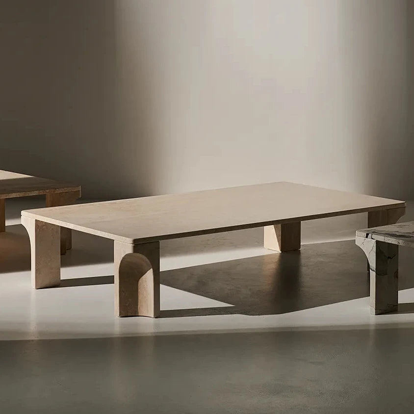 White travertine Doric Coffee Table styled in soft natural light, highlighting its sculptural fluted legs.