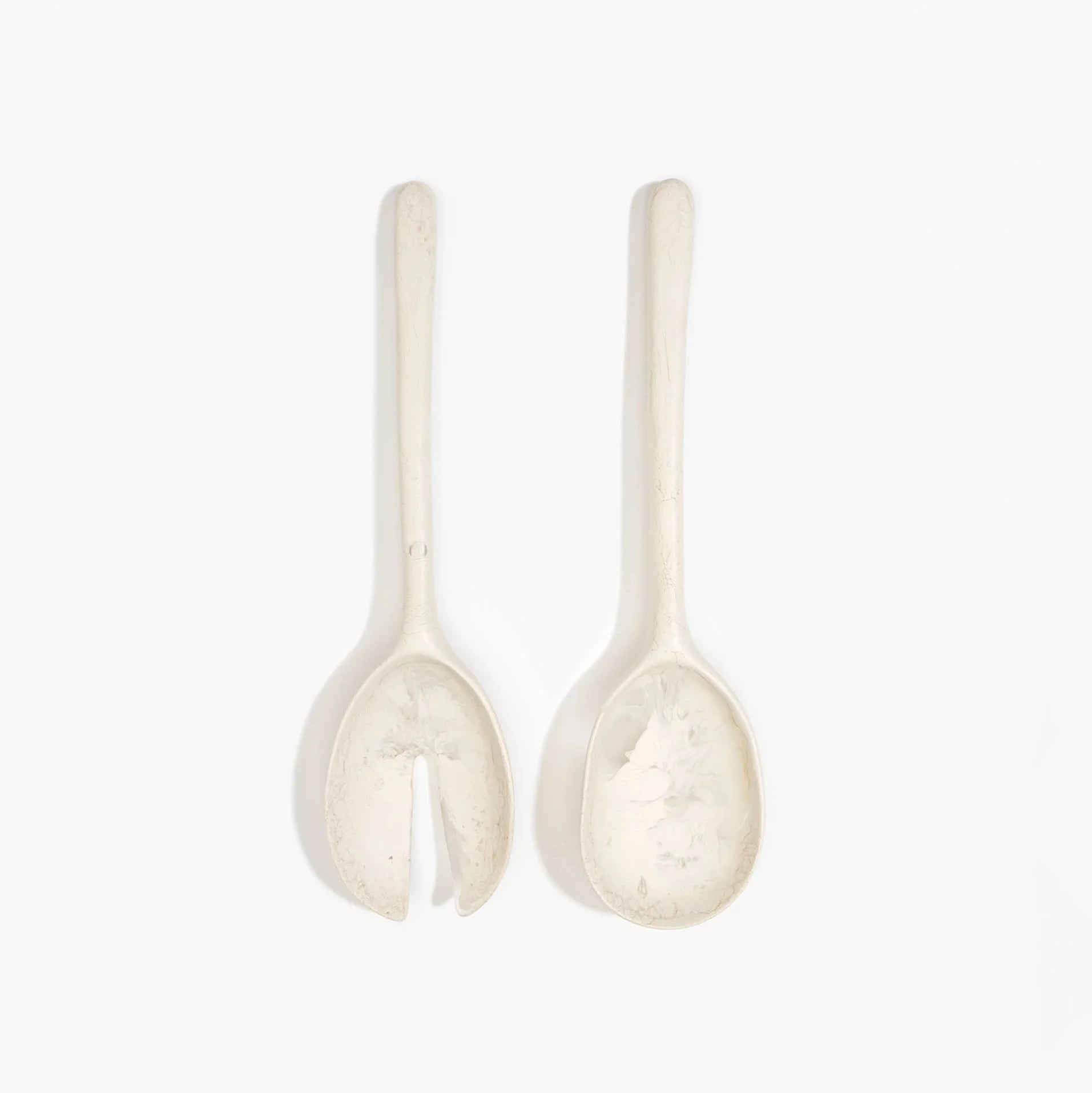 Dinosaur Designs Long Stone Servers in Swirl Chalk resin with sculptural spoon-like shape.