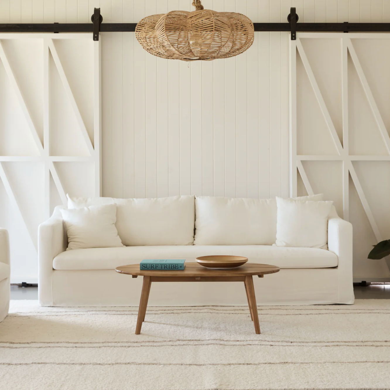 Modern living room with our Ayla Cream sofa, wooden coffee table, and decorative elements.