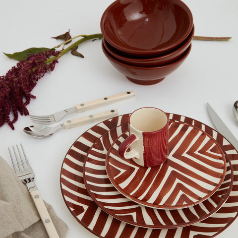 Handmade Moroccan ceramic bowls styled with striped plates and espresso cup in brown and white, artisanal dining set.