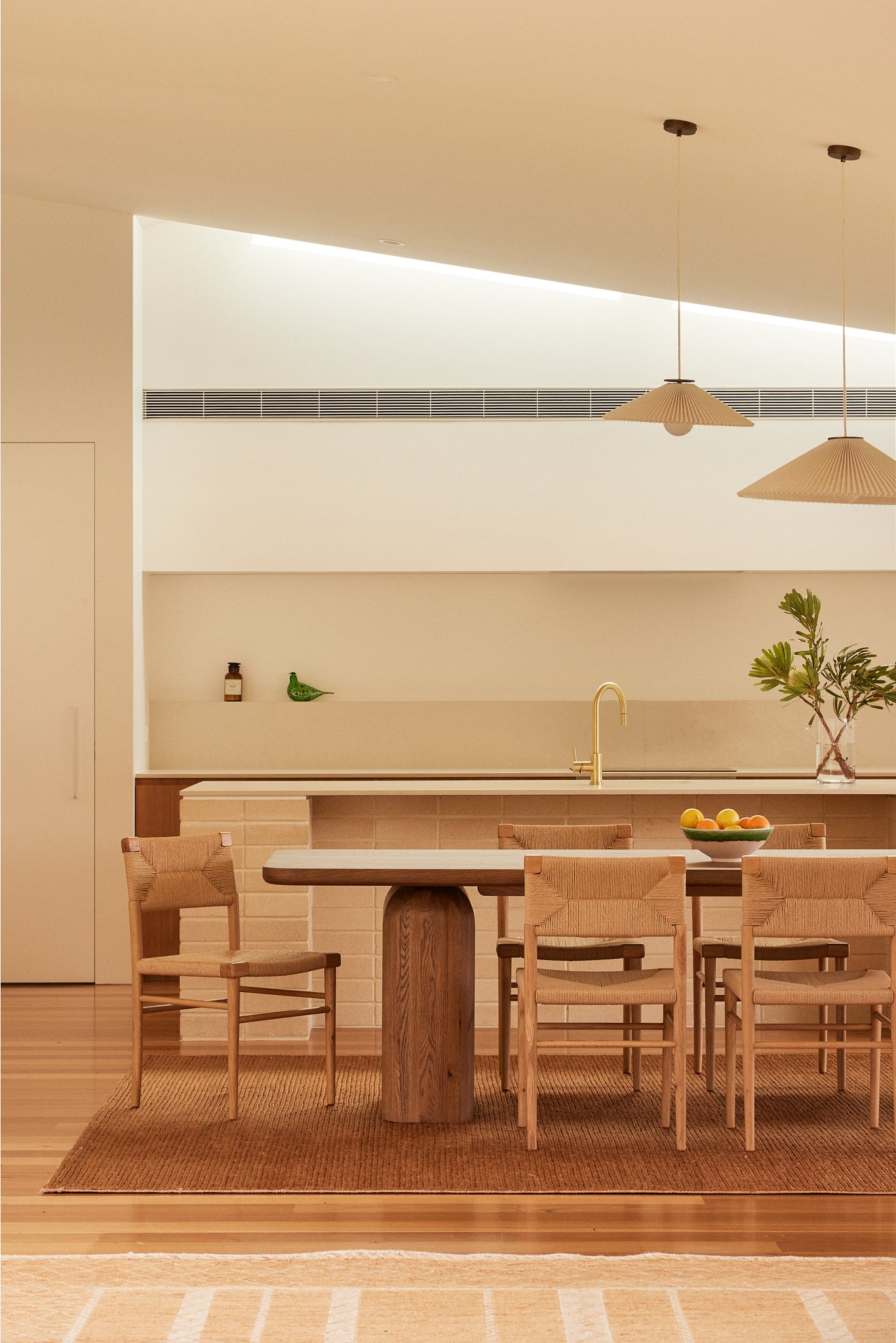 Archer Oak Dining Table with Azul Dining Chairs in oak and woven rope, styled in a contemporary living room