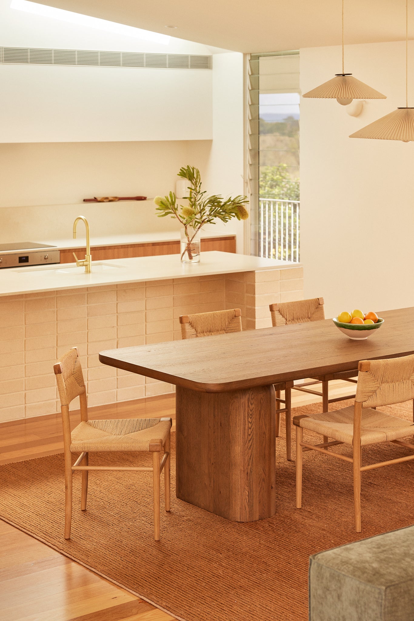 Side view of the Archer Oak dining table styled with the Azul oak dining chairs