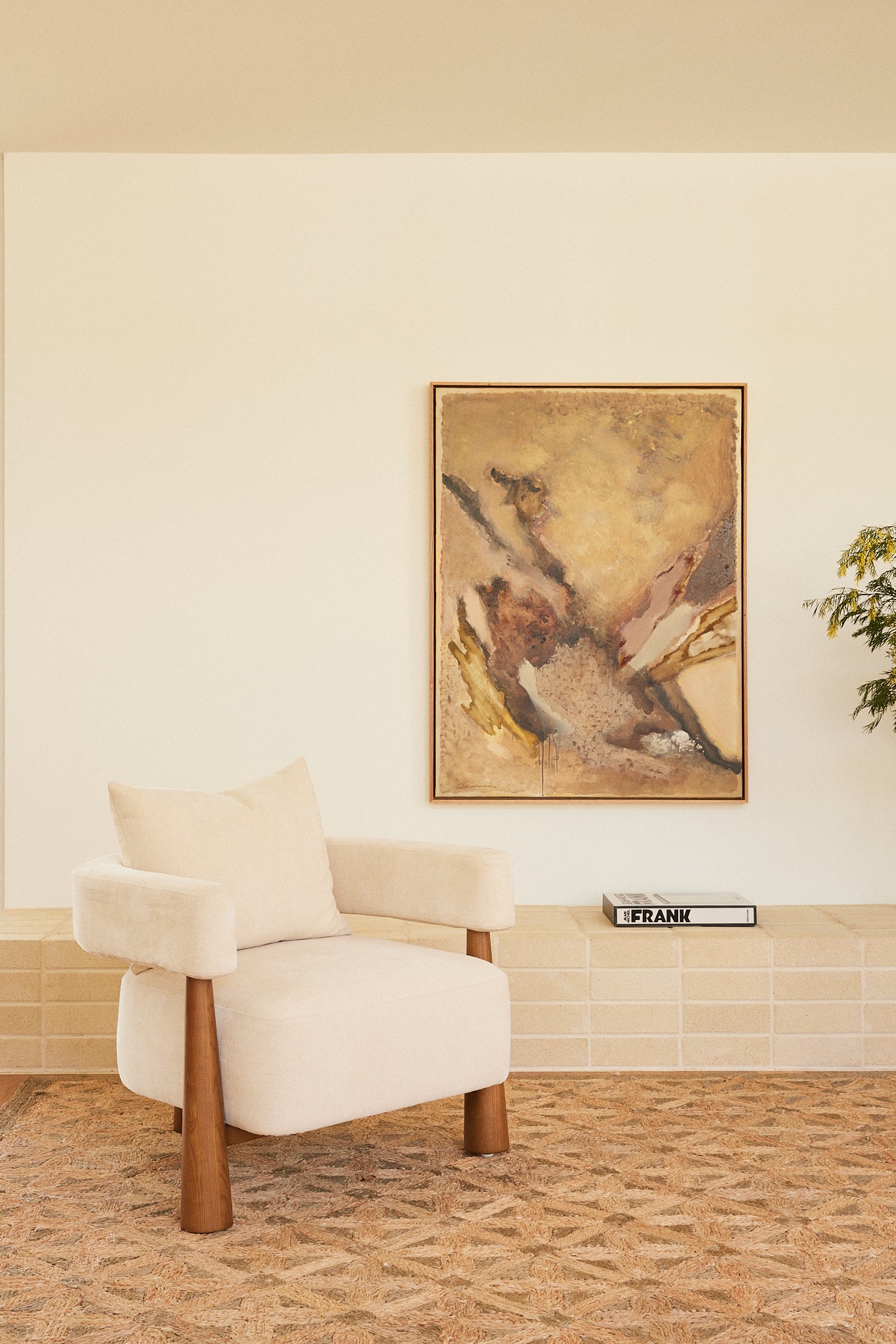 Arlo Armchair in Oatmeal fabric styled in a contemporary Australian living room with original artwork by Stephen Skinner.