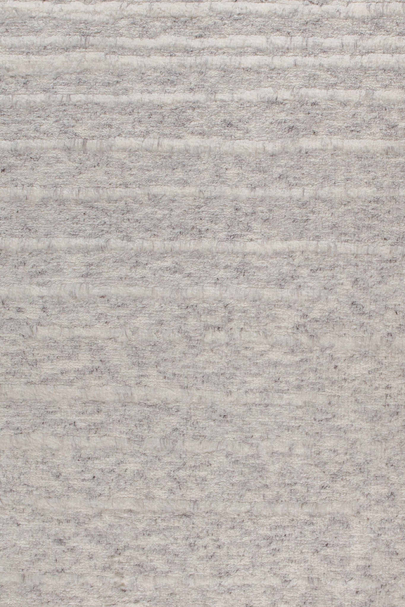 Close-up of Nomad Rustic Stripes rug showing soft horizontal woven texture in natural tones