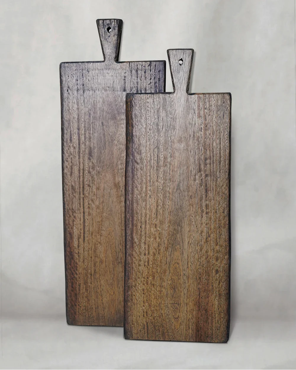 Two natural recycled hardwood chopping boards in varying sizes, showing live-edge grain and smooth oiled surfaces 