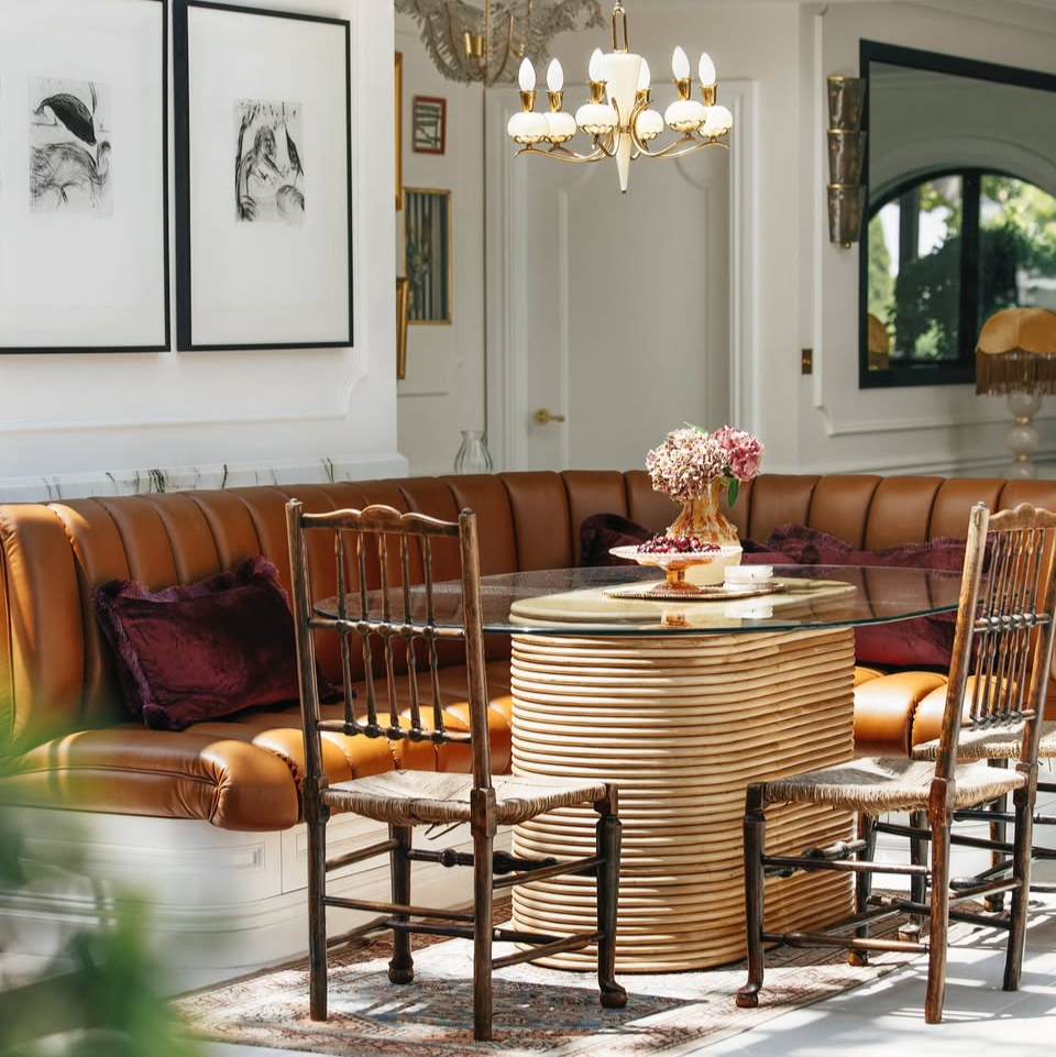 Dining area with our Laguna glass dining table in rattan and decor in a stylish interior setting.