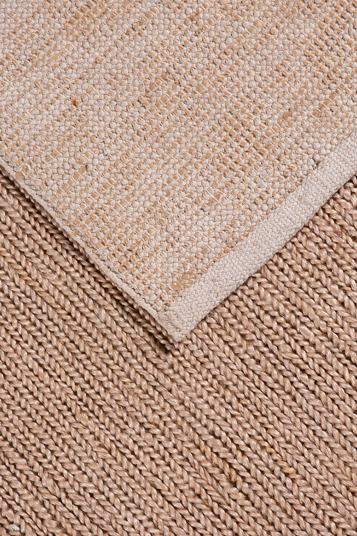 Beige jute twine rug corner detail with woven texture