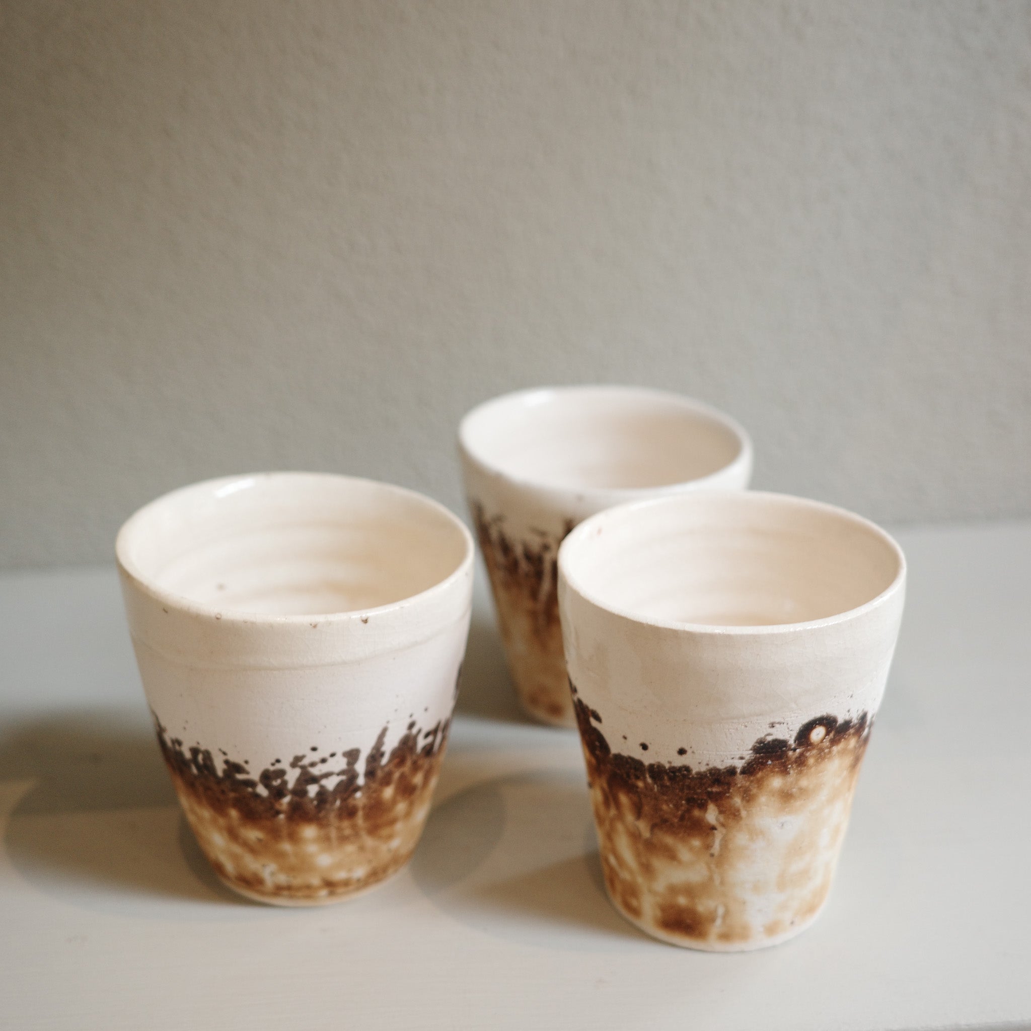 Details of handmade Obvara espresso cups with smoky glaze finish, unique ceramic by Mullumbimby artist Jacqui Sosnowski.