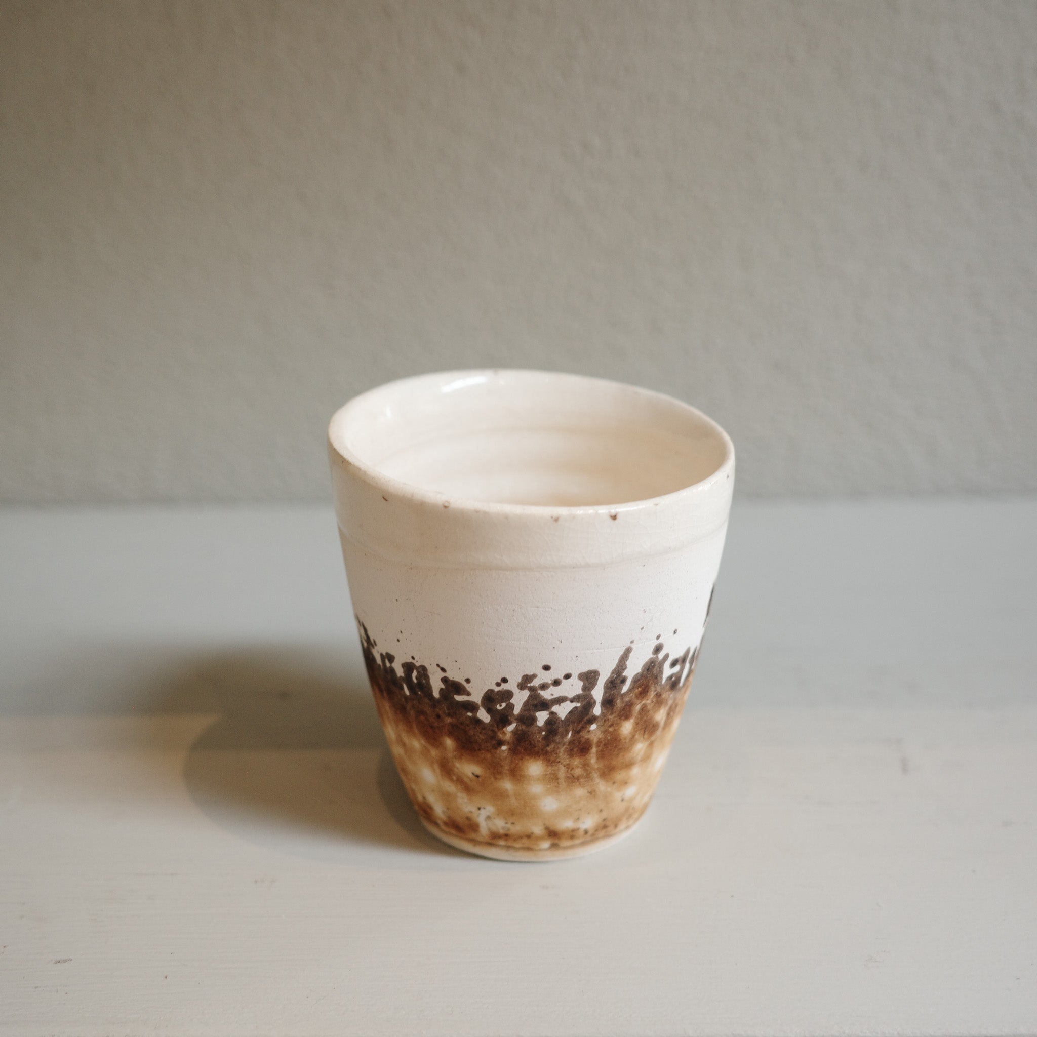 Close-up of Handmade Obvara espresso cup with smoky glaze finish