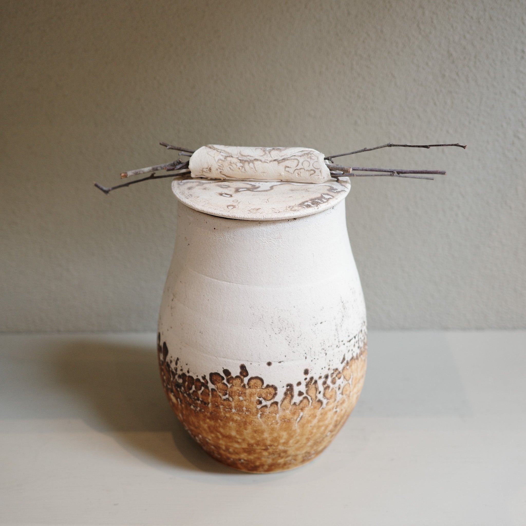 Handcrafted Obvara ceramic jar with lid, in natural earthy tones of cream and brown, by contemporary ceramic artist.