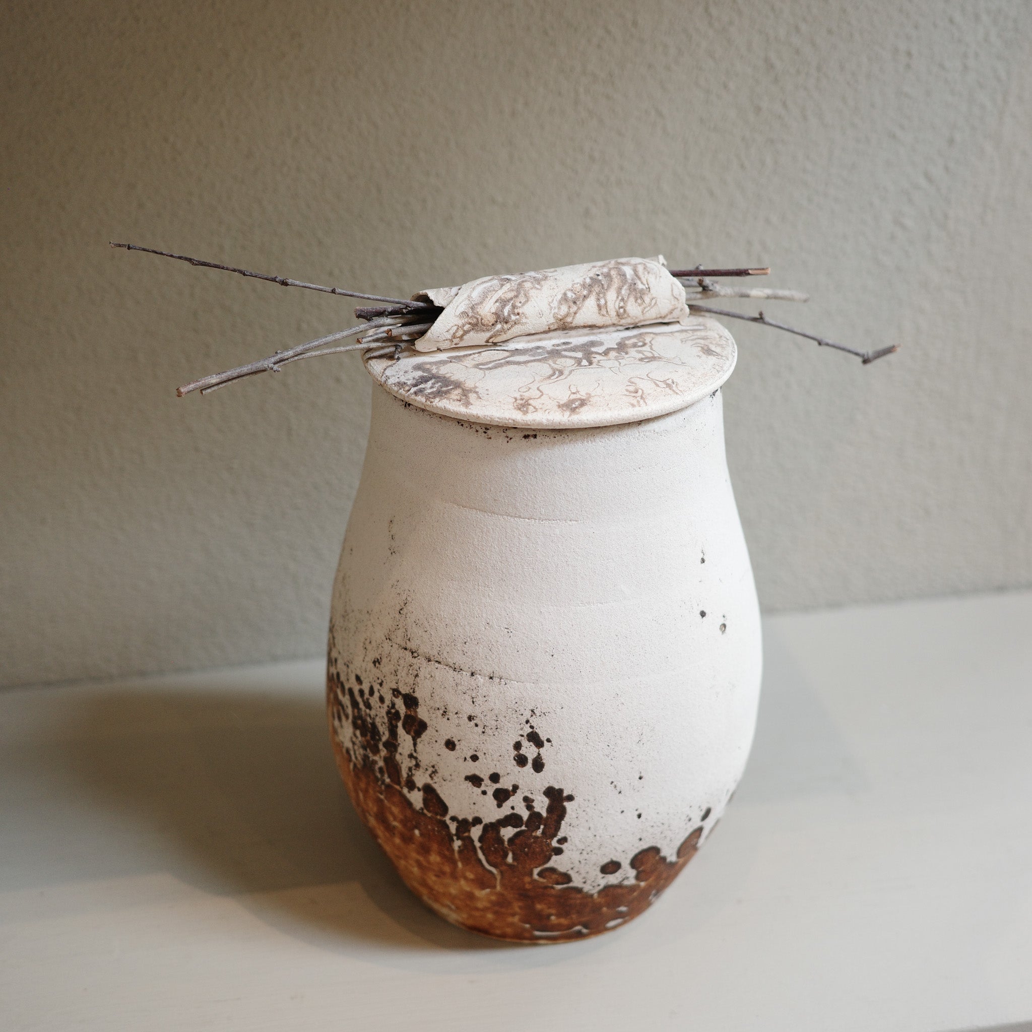 Handcrafted Obvara ceramic jar with lid, in natural earthy tones of cream and brown, by contemporary ceramic artist.