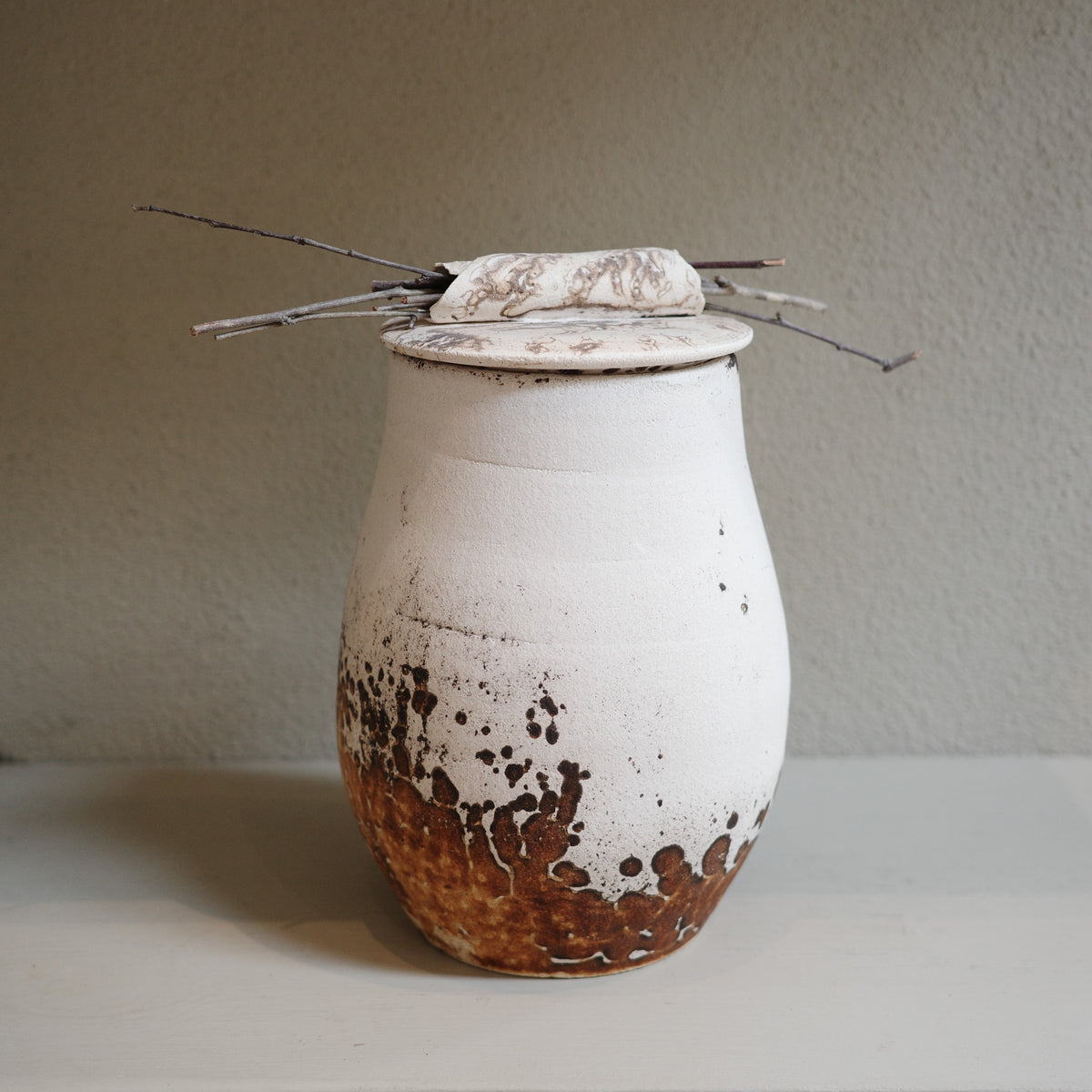 Handcrafted Obvara ceramic jar with lid in natural earthy tones of cream and brown, by contemporary ceramic artist.