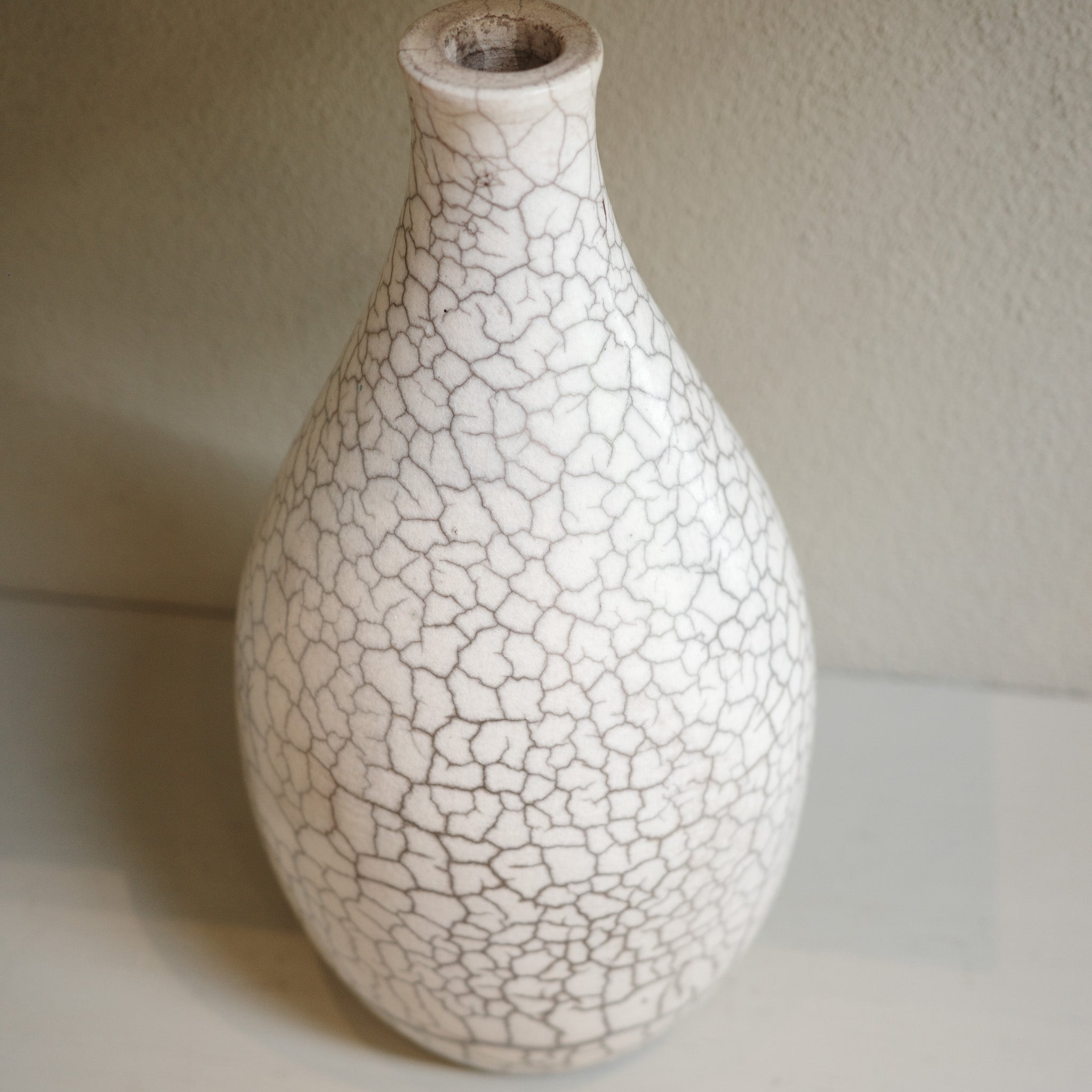 Handmade ceramic raku vase with crackle glaze finish in white and smoky grey by Australian artist Jacqui Sosnowski.
