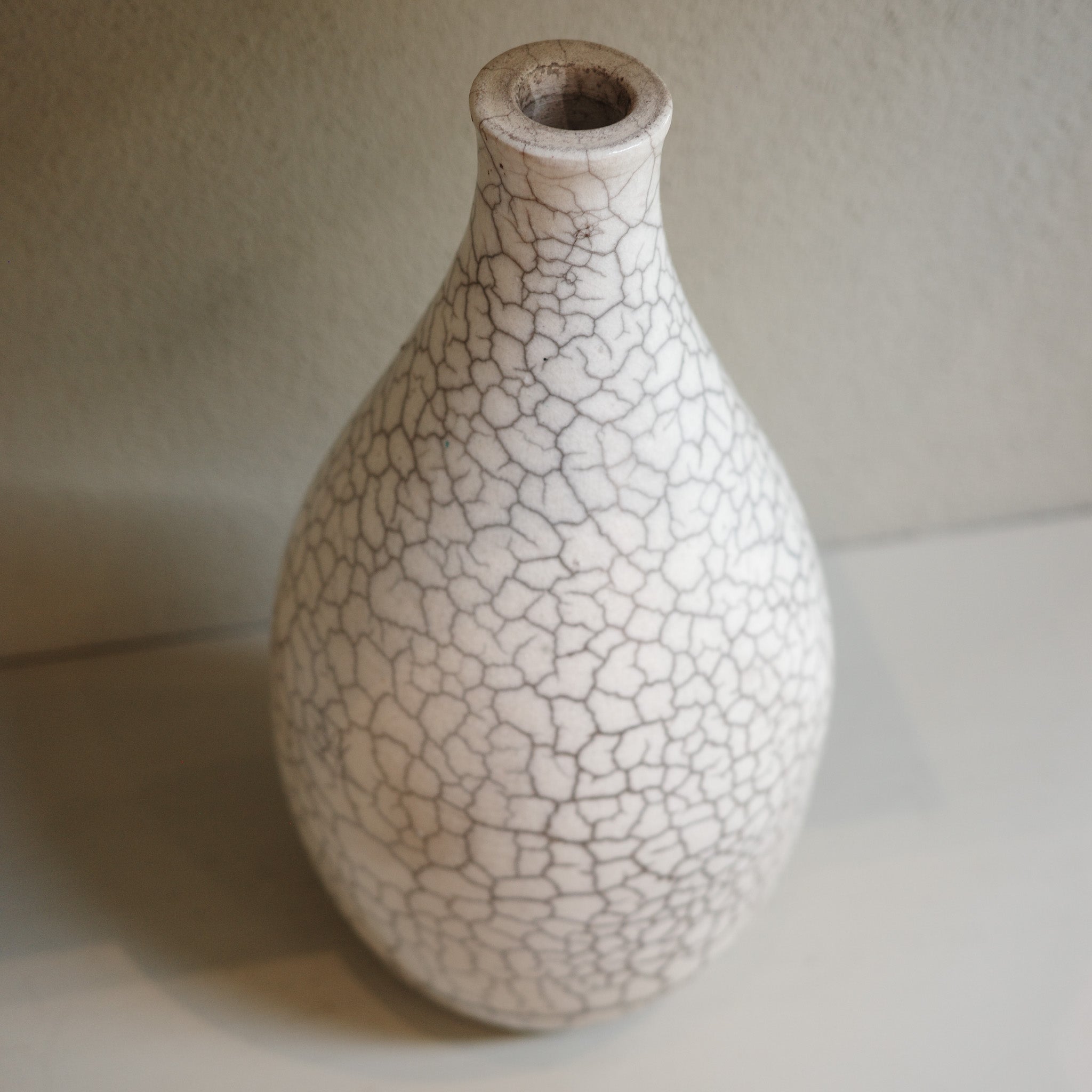 Handmade ceramic raku vase with crackle glaze finish in white and smoky grey by Australian artist Jacqui Sosnowski.