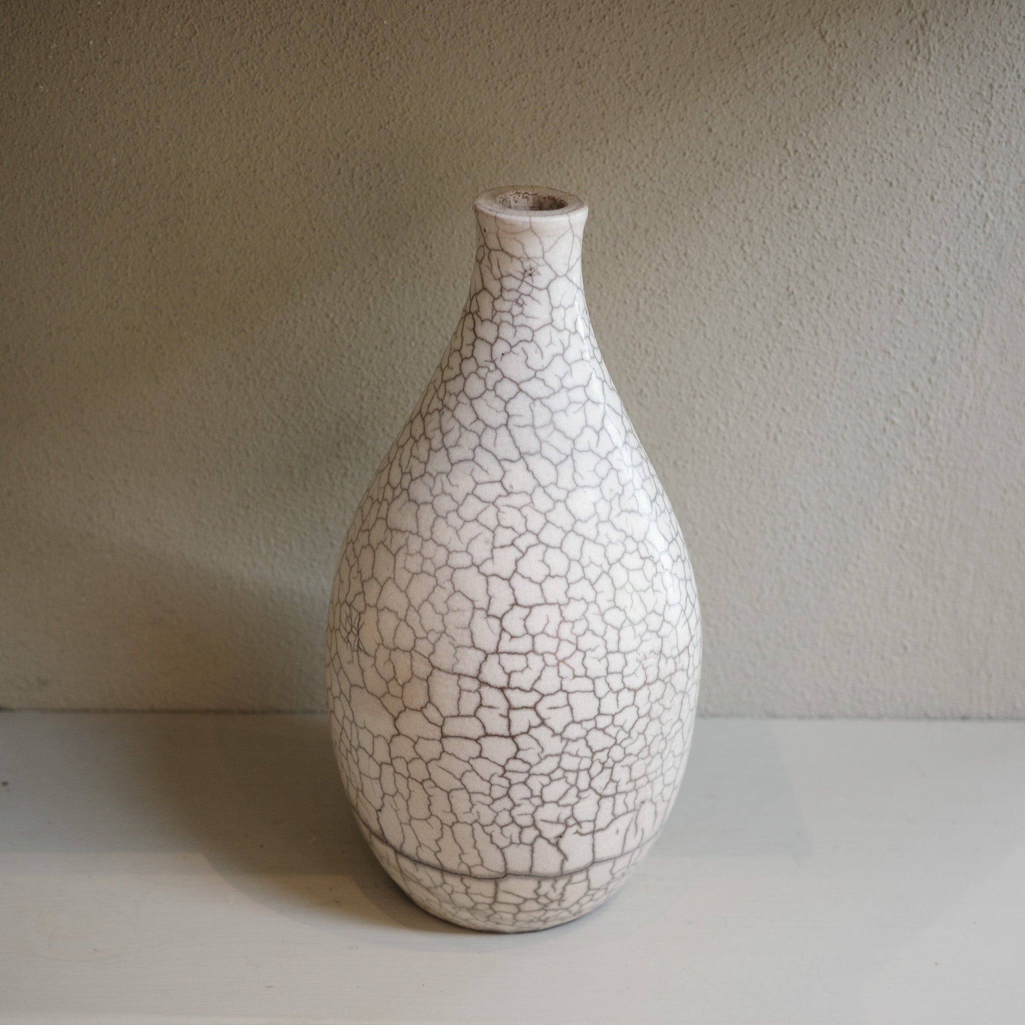 Handmade ceramic raku vase with crackle glaze finish in white and smoky grey by Australian artist Jacqui Sosnowski.