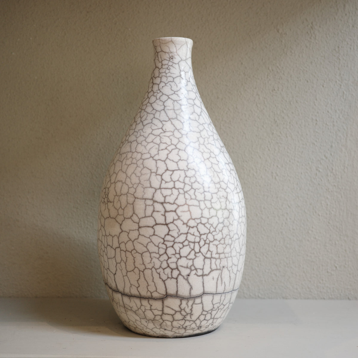 Handmade ceramic raku vase with crackle glaze finish in white and smoky grey by Australian artist Jacqui Sosnowski.