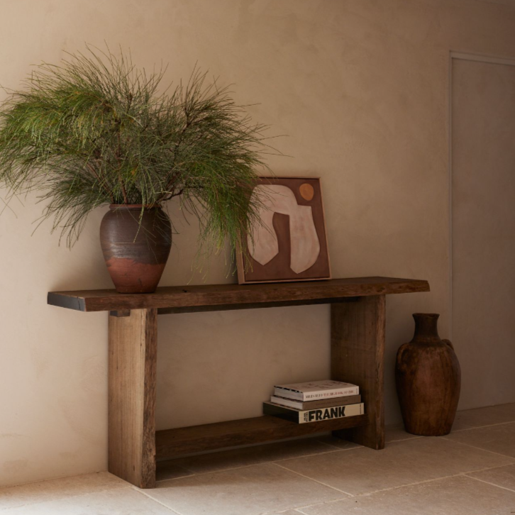 Reclaimed Australian hardwood console with live edge and natural finish, styled with plant and artwork.