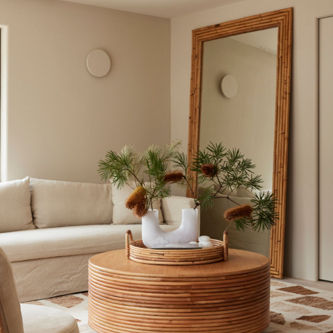 Full-lenght rattan mirror in a modern living room