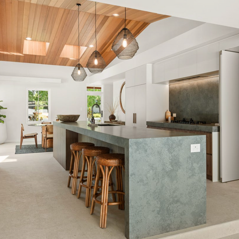 Leila Rattan Bar Stools styled at a modern kitchen island, showcasing its natural finish
