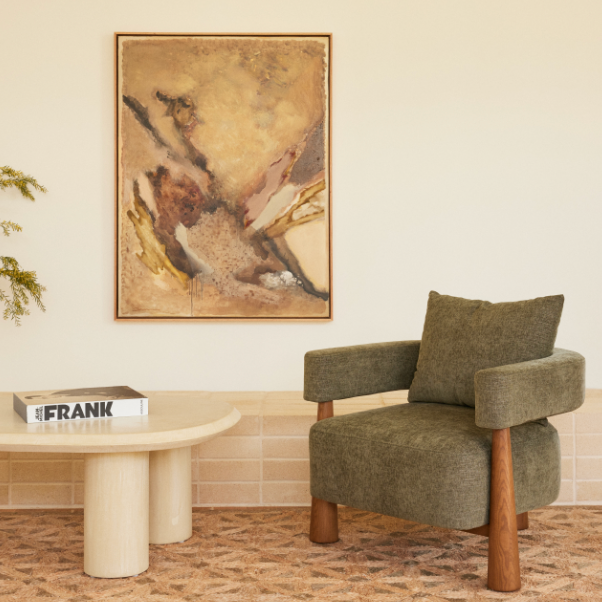Arlo Armchair in Forest fabric styled in a contemporary living room with the Bean Micro-Cement Coffee Table and original artwork by Stephen Skinner.