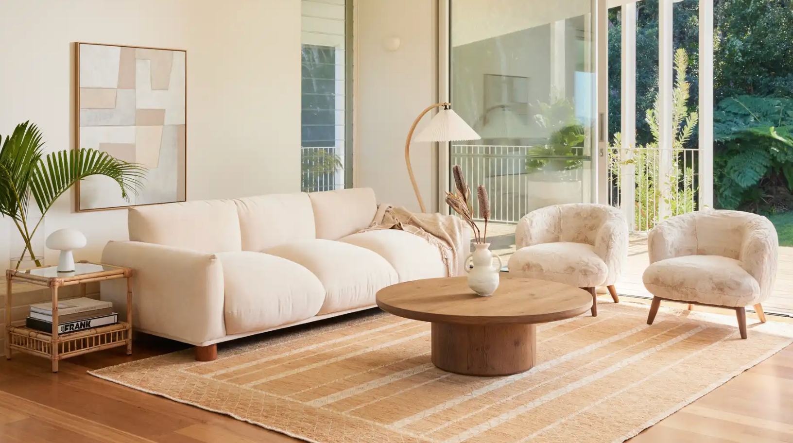 Alta round coffee table in aged brown oak with contemporary Sumi 3-seater sofa