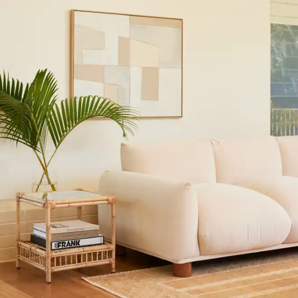 Capri rattan side table beside the Sumi sofa in Oatmeal  in a contemporary living room