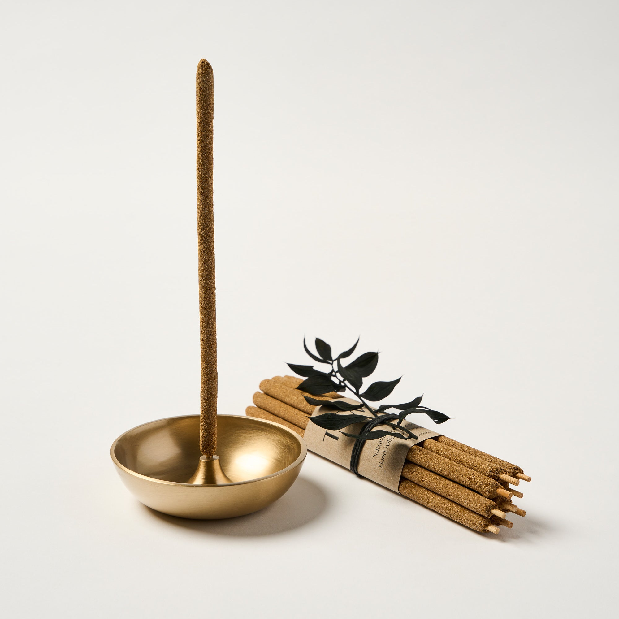 Hand-rolled Palo Santo incense sticks styled with brass incense holder
