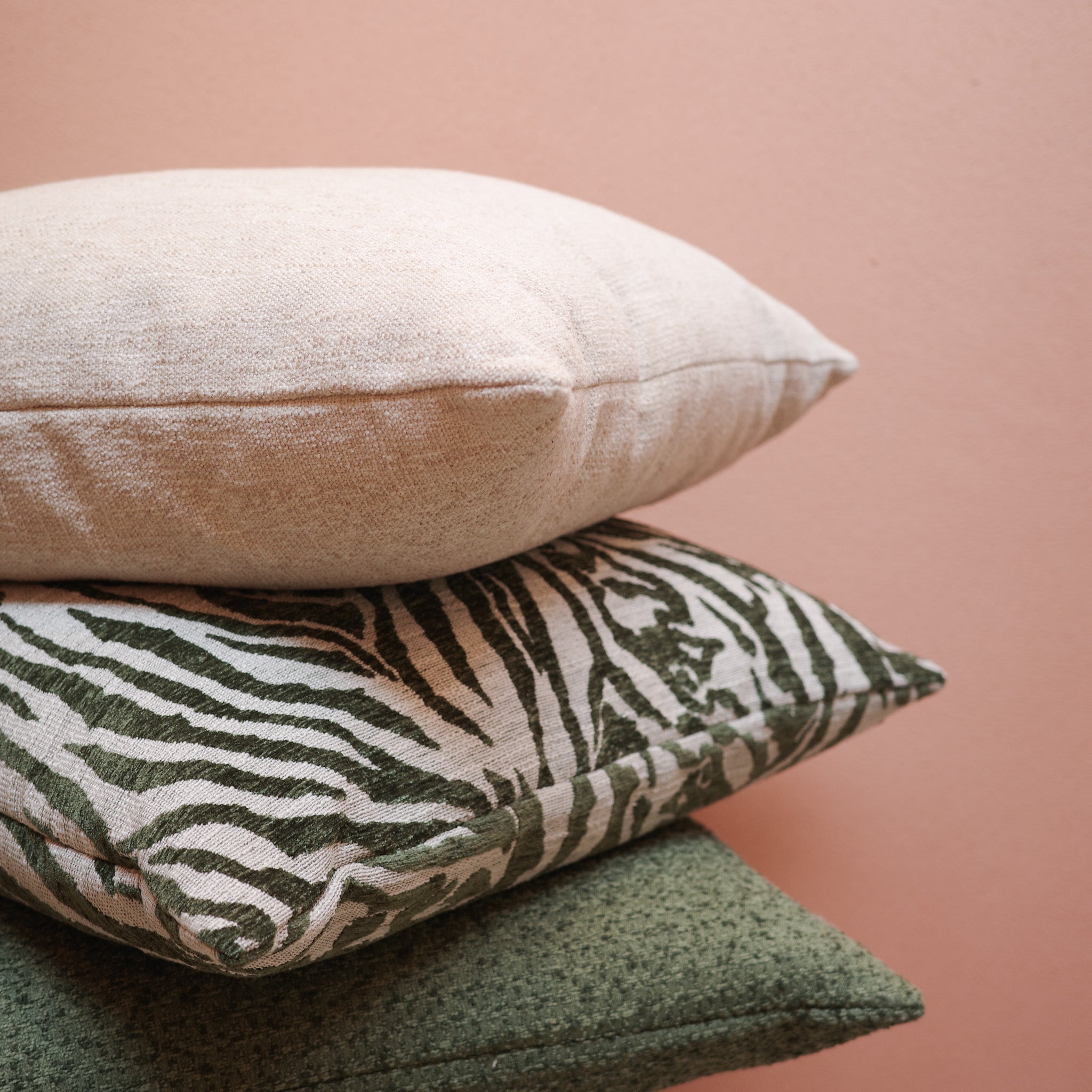 Stack of green and neutral cushions with zebra pattern – Bodhi Living