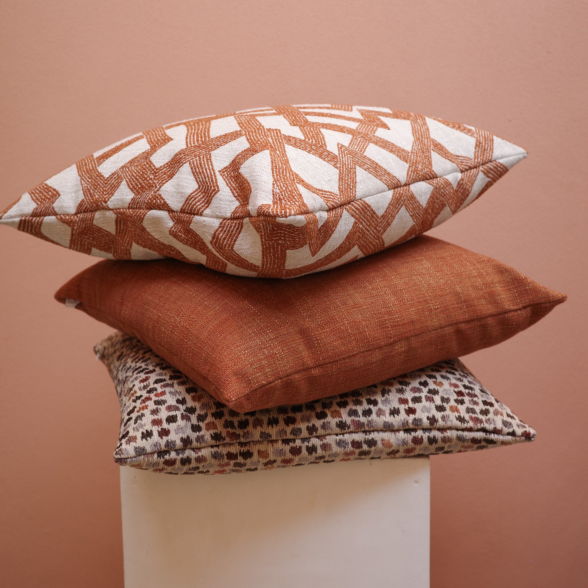 Stack of rust and patterned cushions – Bodhi Living