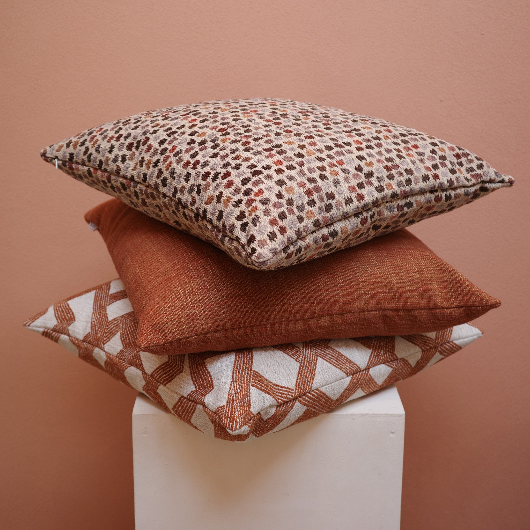 Earthy rust cushion styled with tonal cushions – Bodhi Living
