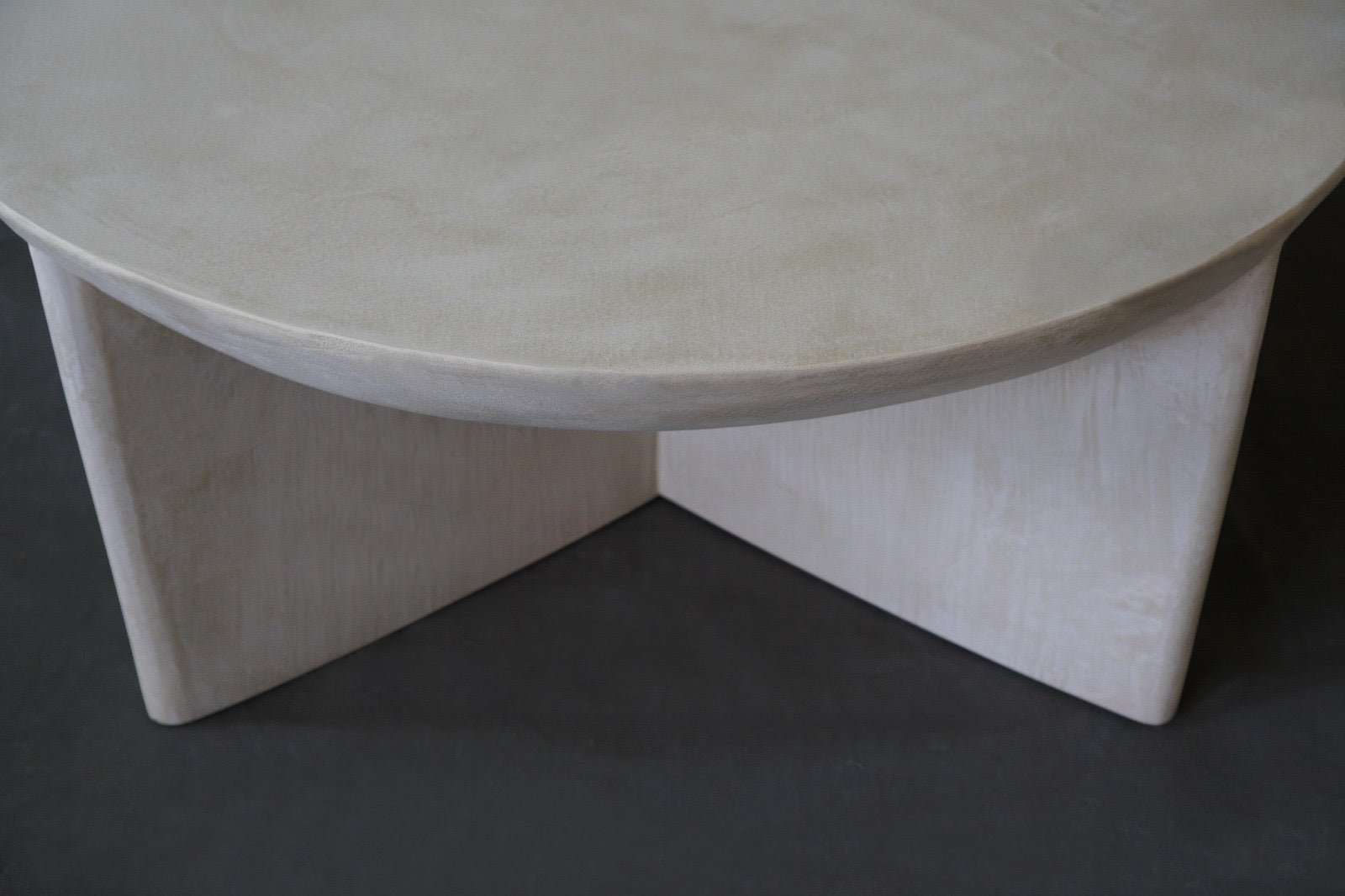 Close-up view of the Axel Round Coffee Table in micro cement in Oyster finish