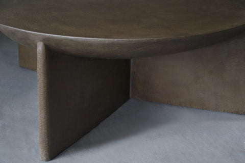 Close-up view of the Axel Round Coffee Table in micro cement in Pebble finish
