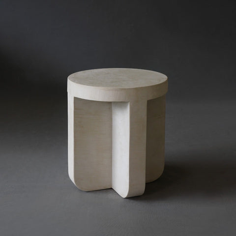 Axel Side Table in Oyster micro cement finish, highlighting its round shape and smooth texture.