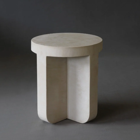 Axel Side Table in Oyster micro cement finish, highlighting its round shape and smooth texture.