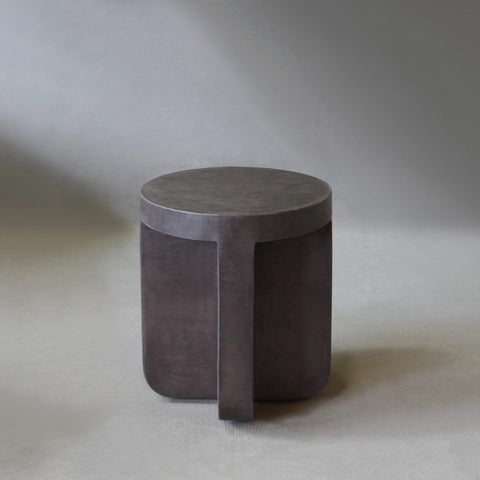 Axel Side Table in Pebble micro cement finish, highlighting its round shape and smooth texture.