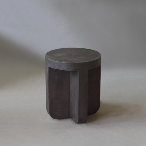 Axel Side Table in Pebble micro cement finish, highlighting its round shape and smooth texture.