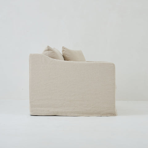 Side view of the Ayla Armchair in Beige Linen fabric loose linen cover