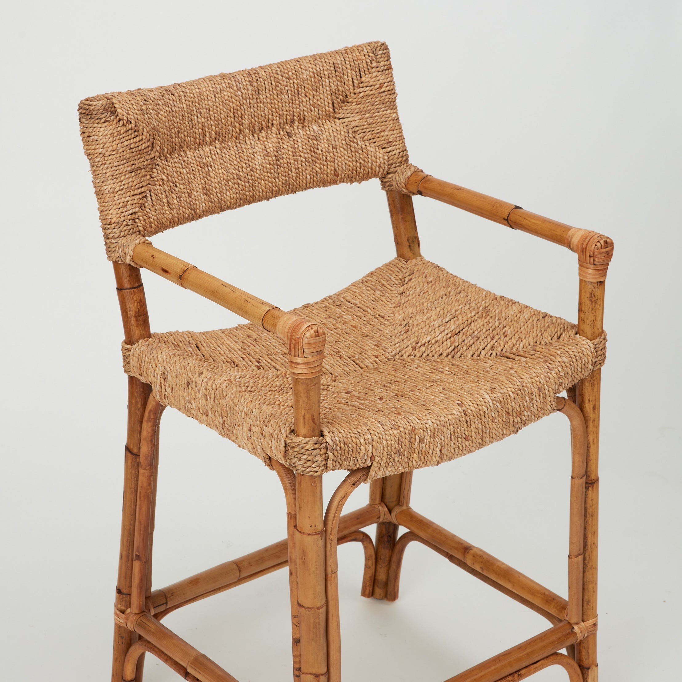 Close-up of Azul Bar Stool with handwoven rope seat and backrest on natural rattan framehe 