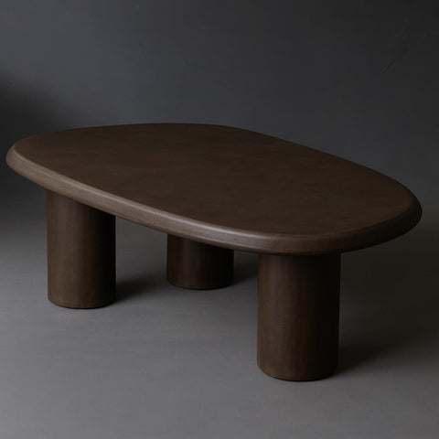 The Bean coffee table features a fluid, organic shape with a Pebble micro-cement finish.