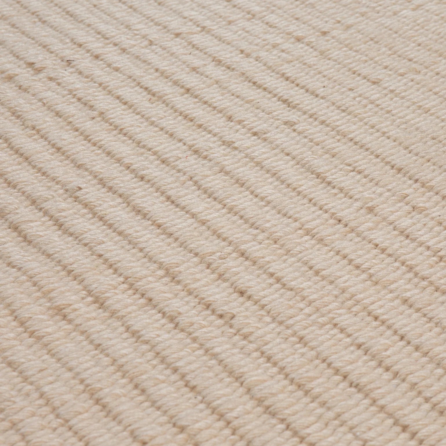 Pebble Flatweave Rug in Beige – handwoven New Zealand wool flatweave with subtle pebble-like texture.