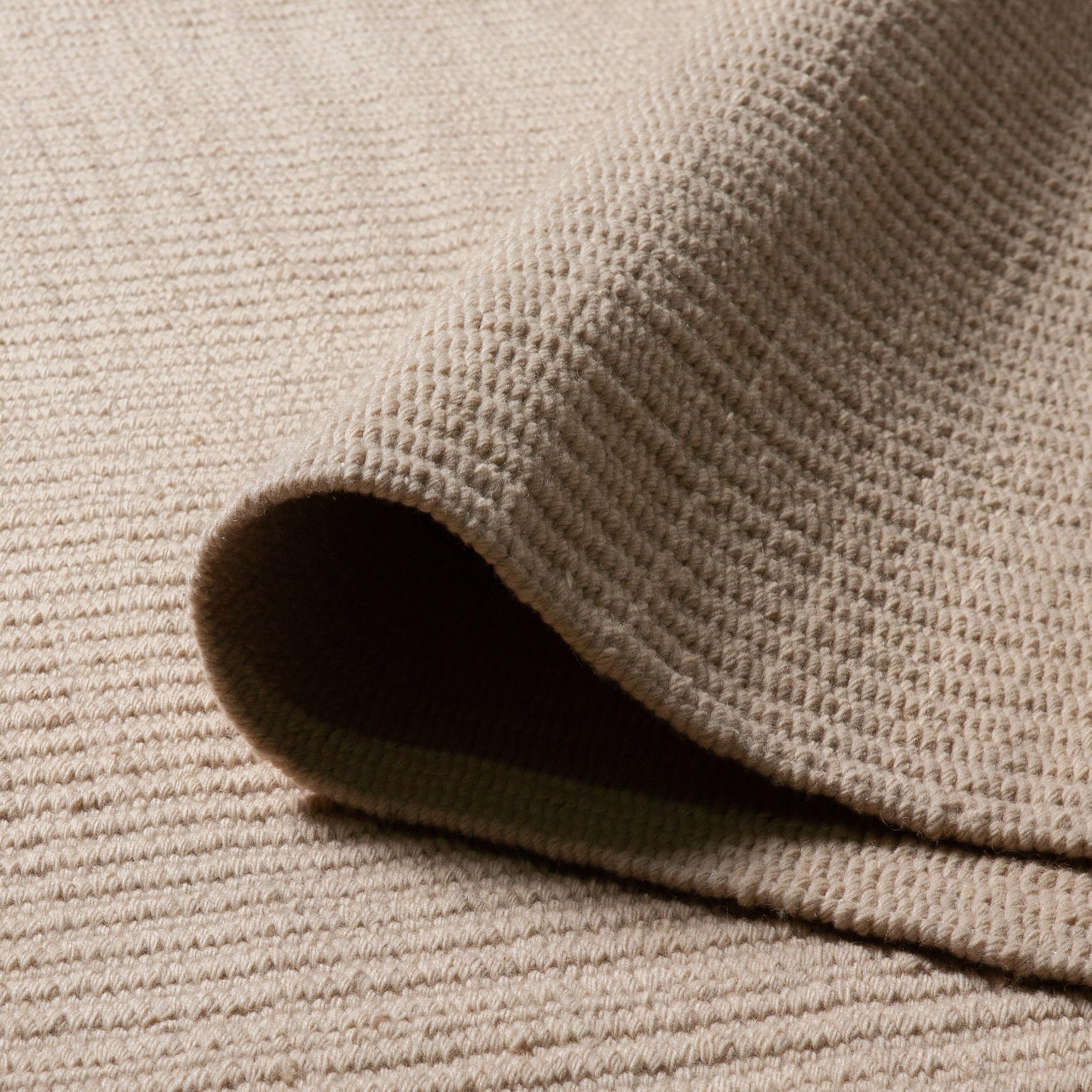 Pebble Flatweave Rug in Beige – handwoven New Zealand wool flatweave with subtle pebble-like texture.